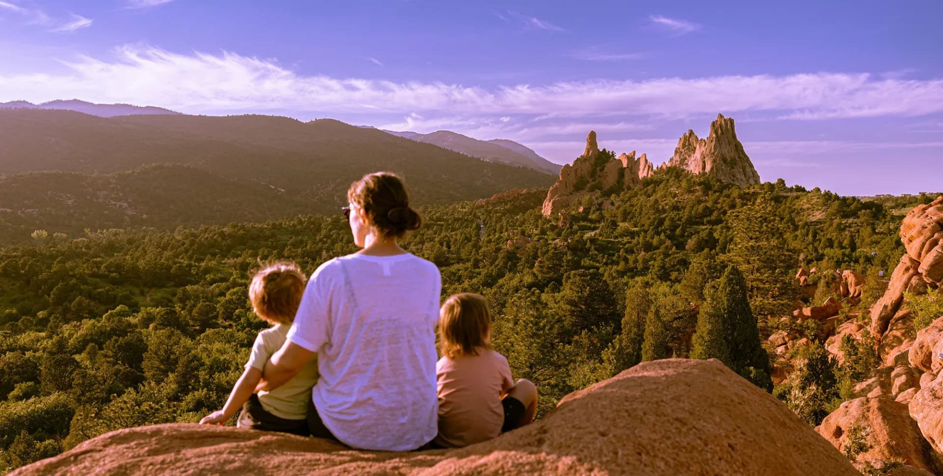 Mother and two children looking out over the Colorado mountains